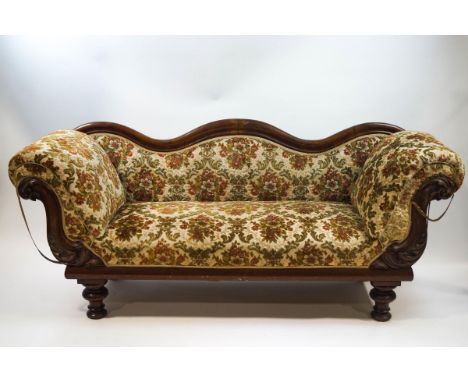 A Victorian mahogany framed sofa with serpentine show back, scroll arms and turned legs. overall 196cm wide x 64cm deep