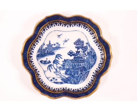 A late 18th century Caughley porcelain teapot stand printed in blue with a Chinoisere scene, within gilt line borders, 15cm d