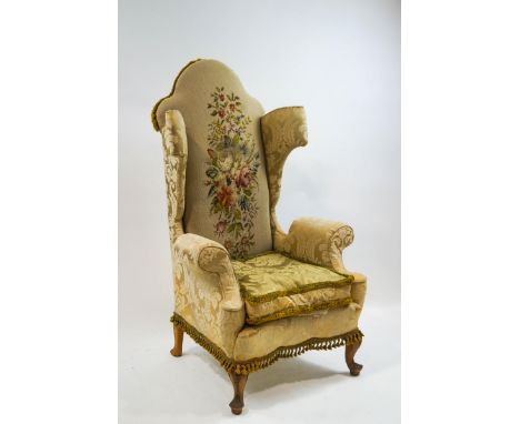 A Victorian walnut wing back armchair with tapestry style upholstery