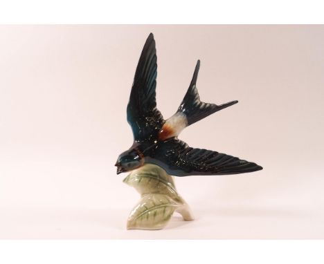 A Goebel porcelain figure of a Red Rumped Swallow in flight, 21.5cm high