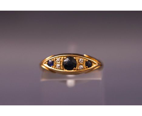 A yellow metal half hoop ring set with sapphires and old cut diamonds. Hallmarked 18ct gold. Size K. Weight: 2.8 grams