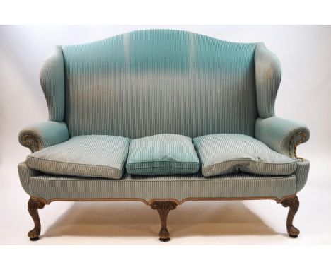 A George III style wing back sofa with scroll arms and carved cabriole legs, overall 170cm wide x 98cm deep