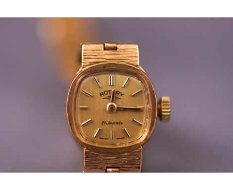 A yellow metal ladies bracelet wristwatch. Cushion gold dial with baton markings. Signed Rotary. mechanical movement. Hallmar