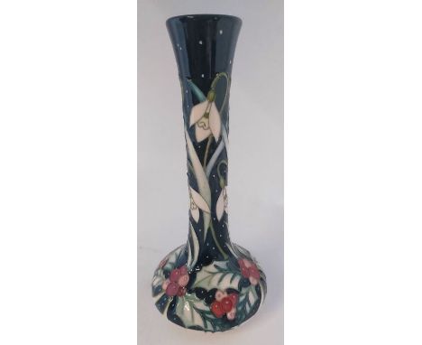 A Trial " Light of the world " vase, it is decorated with Holly and berries and hanging white headed flowers, on a dark blue 