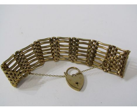 9ct YELLOW GOLD 7 BAR GATE BRACELET, with heart padlock clasp, approx. 46.7 grams 