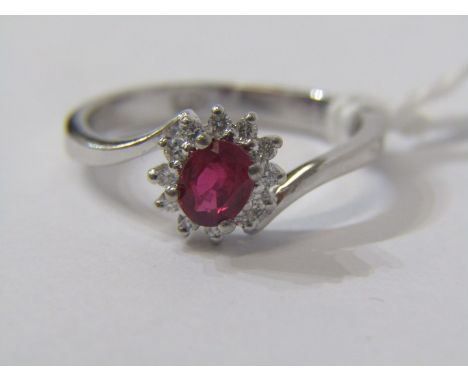 18ct WHITE GOLD RUBY &amp; DIAMOND CLUSTER RING, unusual cross over design, principal oval cut ruby surrounded by brilliant c