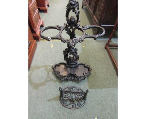 ANTIQUE CAST IRON BLACK ENAMEL STICK STAND, floral and shell design; together with metal boot scraper 