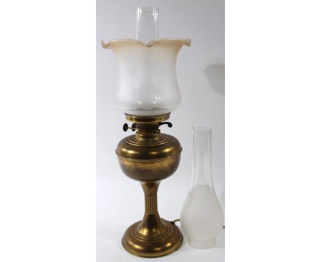 An early 20thC brass oil lamp, a frosted and clear glass shade, and clear glass reservoir, with electrical feature, 59cm high