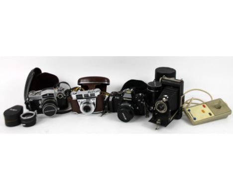 Various camera equipment and lens, to include camera 10cm high, with 50mm 1:1.8 lens, Soligor and other accessories, etc. (a 