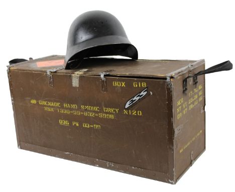 An army helmet, of shaped outline in black, with leather inner strap no. F82078, 19cm high, and an ammunition crate stamped W