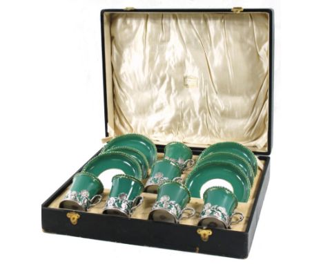 A Royal Worcester porcelain part coffee set, with silver holders, c.1910, green fluted with green trim, the holders repoussé 