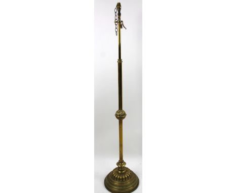 An early 20thC brass standard lamp, with cylindrical stem, on a gadrooned and stepped circular base, with later fittings, 172