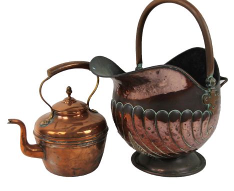 An early 20thC copper coal helmet, of part gadrooned outline on circular foot, with double handle, 50cm high, and a copper ke