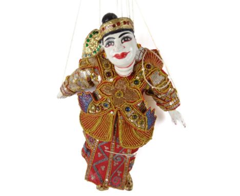 An Eastern articulated puppet, with wooden head, articulated features, dressed in finery, with wooden 'H' shaped strung secti