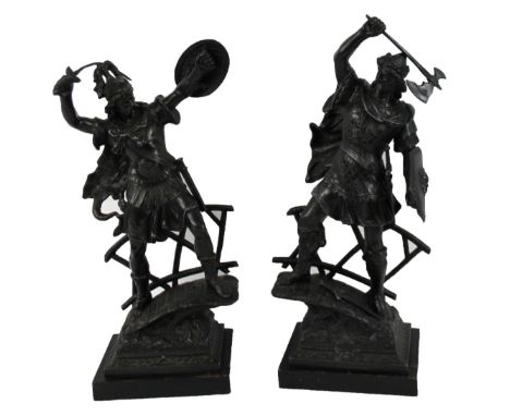 A pair of modern hollow cast metal figures of warriors, the first holding axe, the second holding a sword, each in flowing ro