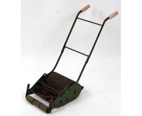 An mid 20thC child's push lawn mower, with cylindrical roller, wooden front and shaped handles, 51cm high.