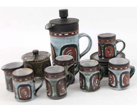 A Briglin Studio pottery part service, to include cups 8cm high, saucers, coffee pot, etc., each part sgraffito decorated wit