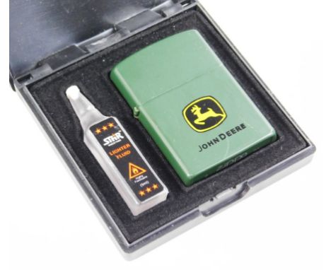 A Zippo John Deer lighter, in green trim, 6cm high, with lighter fluid. (boxed)