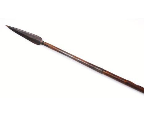 An African tribal Zulu spear with cane stem and arrow point end, 153cm wide.