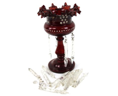 A Victorian ruby glass single lustre, the flared handkerchief top raised on a dumbell stem and circular foot with a number of