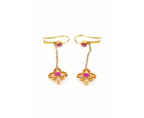 A pair of ruby and diamond earrings, of floral design, with extended drop. the flower set with ruby and surrounded by four ti