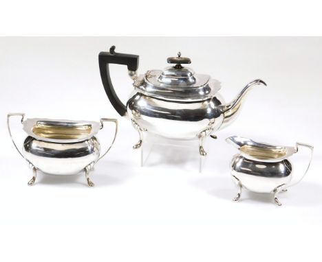 A George V Silver three piece tea service, by Walker & Hall, comprising teapot of cape form, 18cm high, with angular handle, 