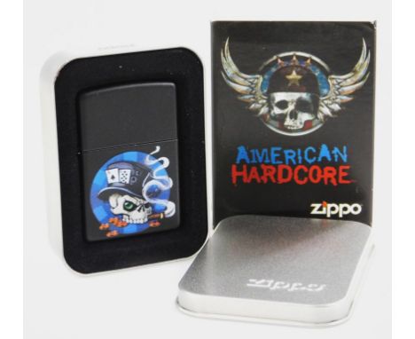 A Zippo American Hardcore lighter, 6cm high. (in outer tin and card packaging)