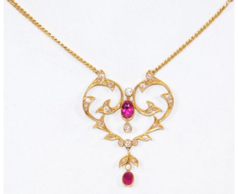 A ruby and diamond Art Nouveau style pendant, the pendant set with two oval cut rubies and various tiny diamonds, the pendant