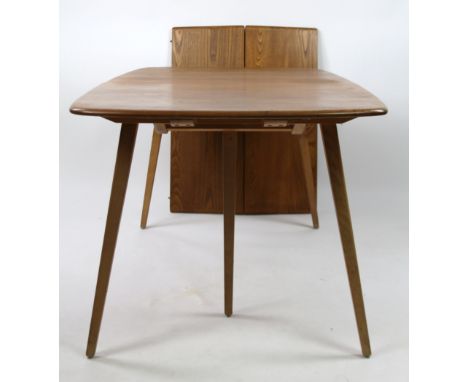 A mid 20thC Ercol light elm extending dining table, with rounded ends on a shaped support with folding leaf (when extended) 7