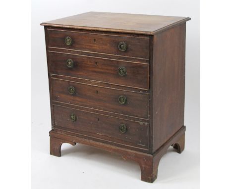A George III mahogany chest commode, the dummy front hinging at the centre, with four long cockbeaded drawers, each with circ