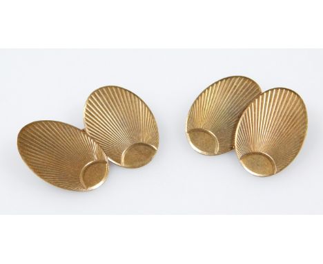 A pair of 9ct gold cuff links, each with oval ends and chain centres, partially engine turned, 1.5cm high, 5g. (2)