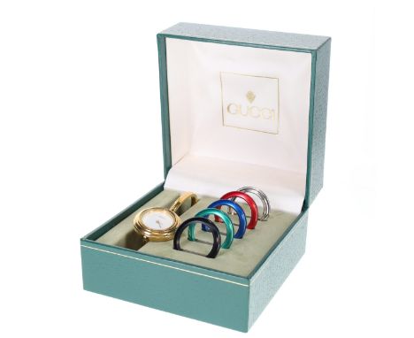 Gucci - 11/12.2 Gold Tone Interchangeable Bezel Quartz Watch. Swiss made quartz movement. Case and bracelet made from gold to