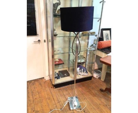 A contemporary floor lamp, the circular blue shade on a chrome stand, with pierced teardrop, on rectangular base (152cm to to