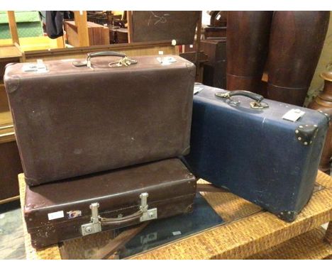 A group of three vintage carrying cases, one blue, stamped Globetrotter (24cm x 72cm x 44cm), two brown (3)