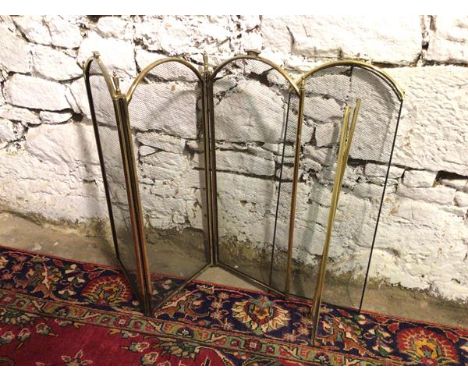 A brass effect three fold firescreen (84cm x 97cm), with possible fourth additional screen