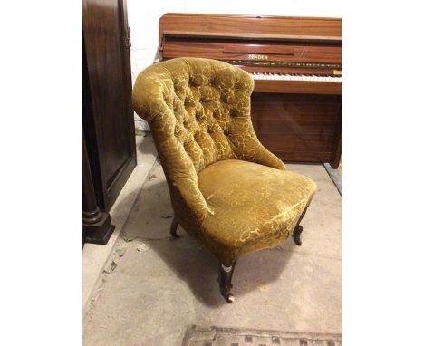 A Victorian nursing chair, with button back in a cut velvet upholstery, with floral decoration, on moulded front supports ter