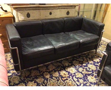 A Le Corbusier style sofa, with black leather back, sides and seats, on chrome tubular frame and supports (68cm x 180cm x 74c