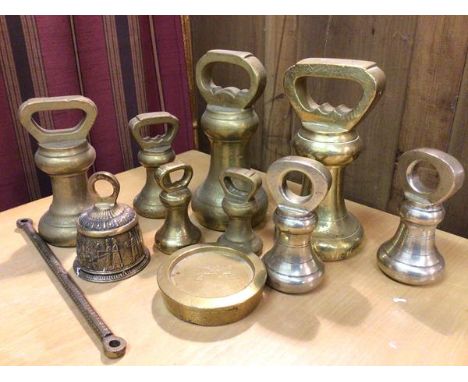 A collection of brass weights, largest 7lb (17cm), a brass bell (11)