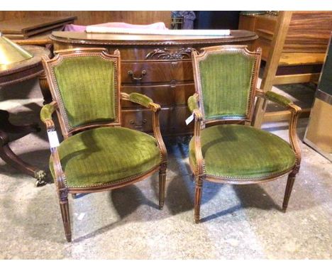 A pair of early 19thc French walnut fauteuil, each tapering back with foliate finial within outswept arms, with scroll termin