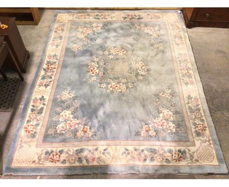 A Chinese rug, with floral medallion and floral bouquets to corners, within a floral border, light blue field (306cm x 246cm)