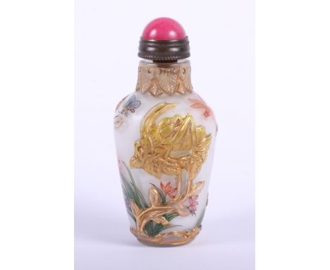 A 19th century Chinese glass snuff bottle with relief decoration, a pink hardstone mounted spoon, four character Chen Lung ma
