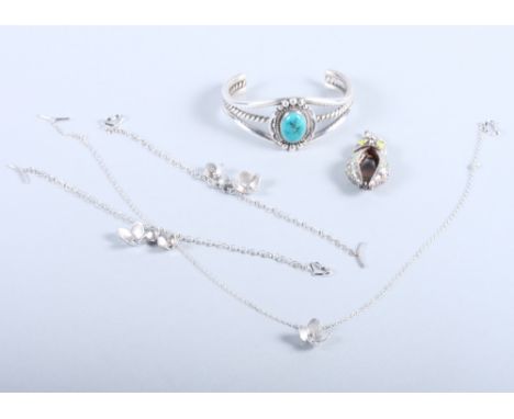 A sterling silver and turquoise Navajo style bracelet by Dan Oliver, a silver and enamel owl pendant and three silver bracele