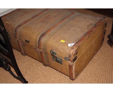 A canvas trunk, a large ebonised tin trunk, two wooden trunks and a wicker basket