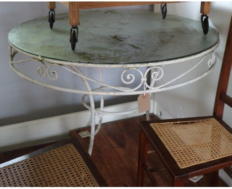 A wrought iron garden table with circular glass panel, 36" dia