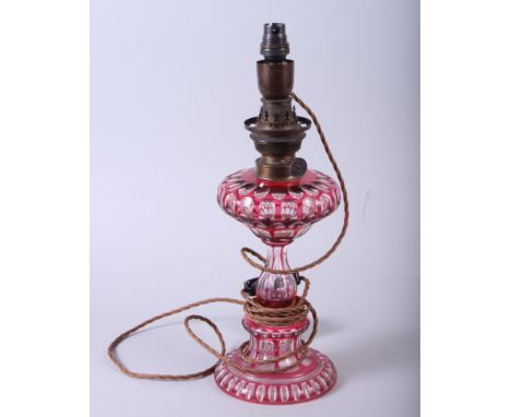 A 19th century ruby cut glass oil lamp (now converted to electricity), 14" high