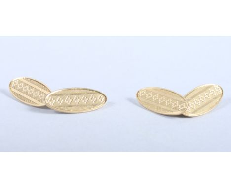 A pair of 18ct gold lozenge-shaped cufflinks with stylised engine turned decoration,with 9ct gold chains, 8g