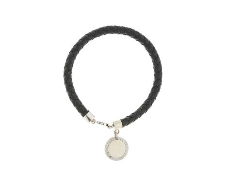An 18ct gold brilliant-cut diamond accent disc charm, suspended from a woven leather bracelet with 18ct gold polished termina