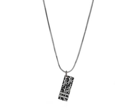 Christian Dior, a vintage Trotter pendant, featuring the maker's iconic trotter pattern pendant on a silver-tone chain, signe