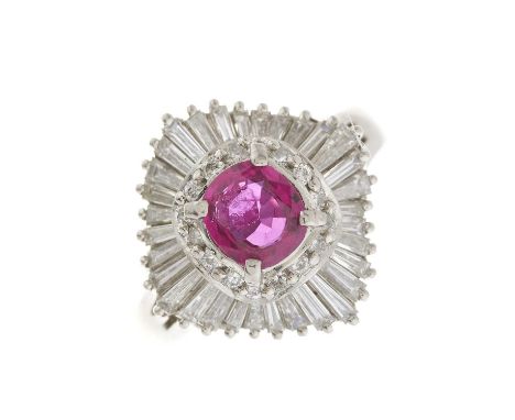 A platinum cushion-shape ruby and brilliant-cut diamond cluster dress ring, with tapered baguette-cut diamond undulating surr