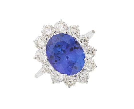 An 18ct gold tanzanite and brilliant-cut diamond cluster ring, with tapered baguette-cut diamond shoulders, tanzanite estimat